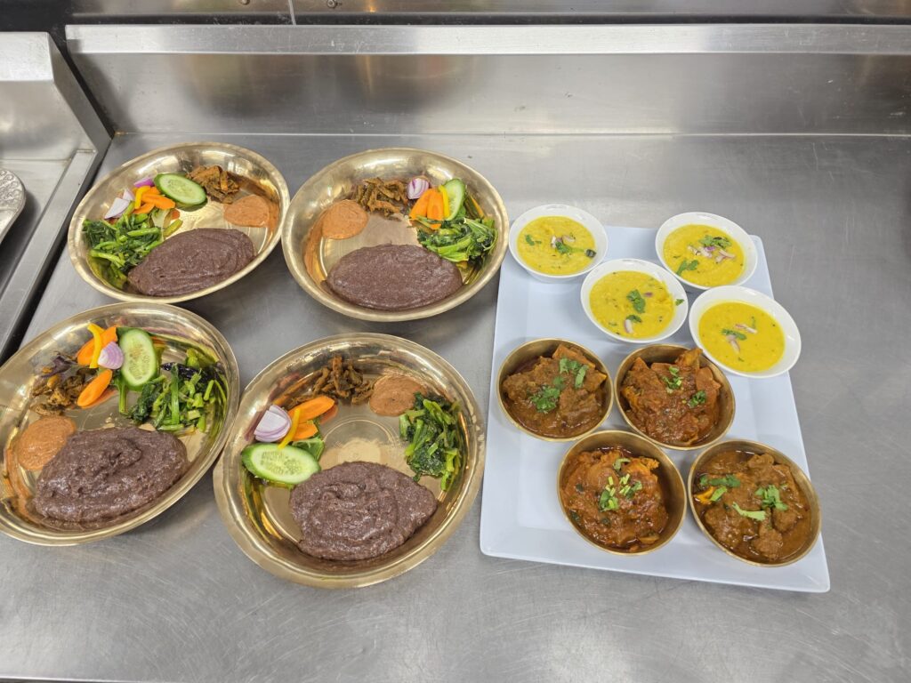 Full table of Nepali dishes at Raato Ghar including momos, jhol momo, sekuwa, dal bhat and mango lassi for first-time diners